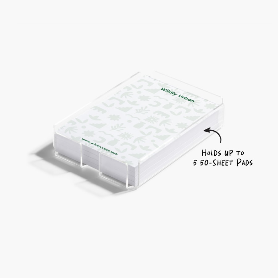 A closeup of an acrylic Post-it® holder, showing it has room for up to 5 50-sheet pads.