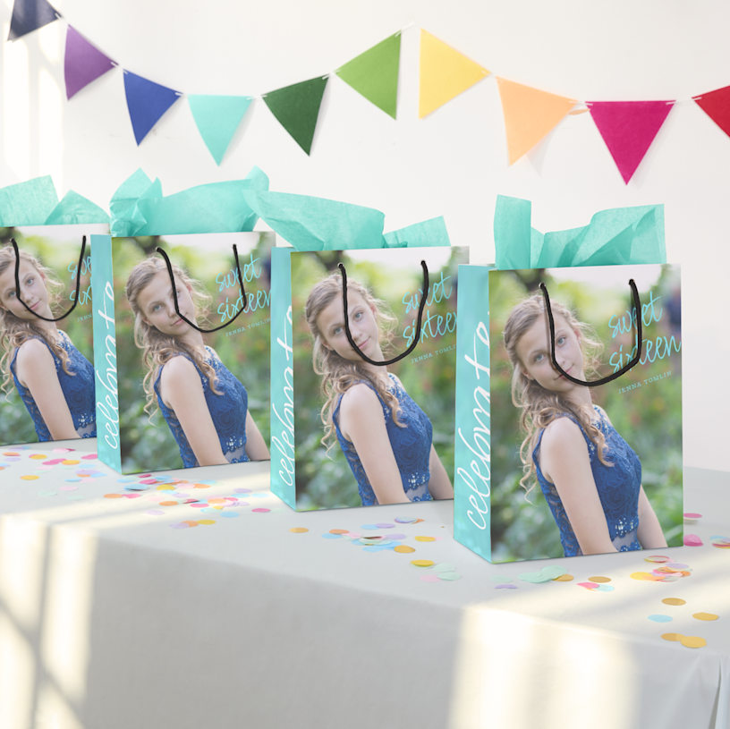 Shows an array of multi-coloured bags spread out like a fan with the words Tennis Club printed on them. 