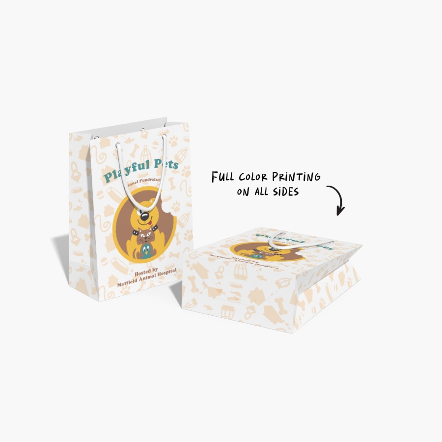 Two bags, one standing up and the other laying down with a sophisticated coloured print of black and gold.