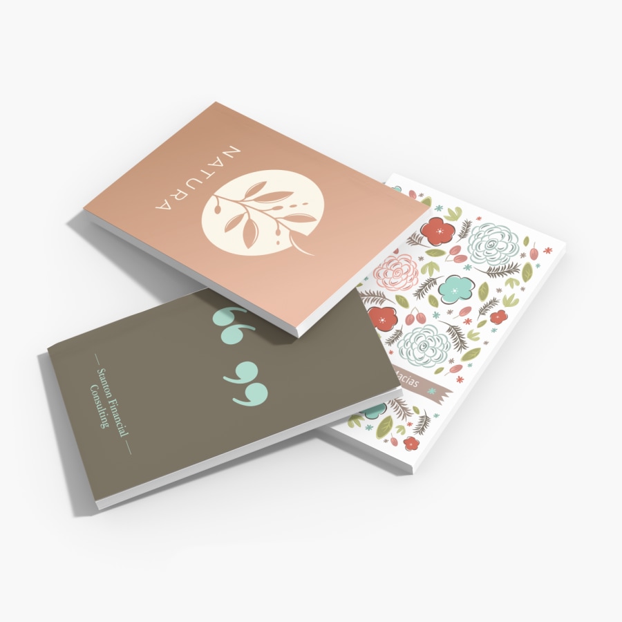 A stack of 3 custom journals with different cover designs.