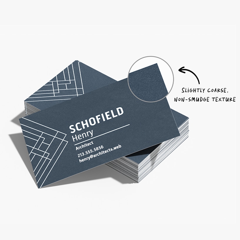 A stack of fine grit business cards, showing a closeup of the textured surface.