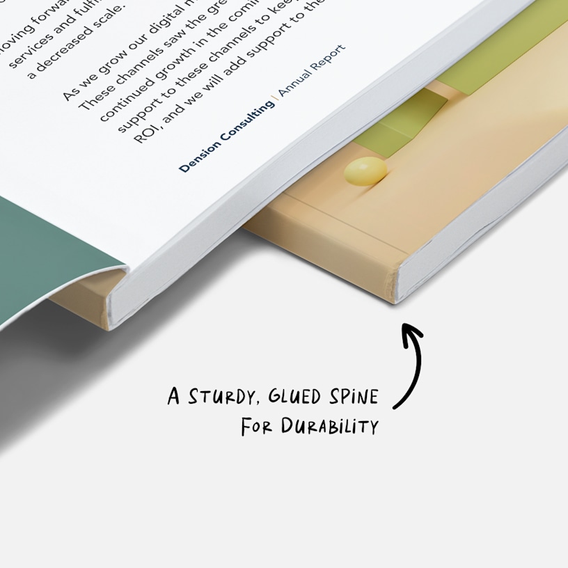 A close-up of a perfect bound book’s glued spine, with a written note, "A sturdy, glued spine for durability."