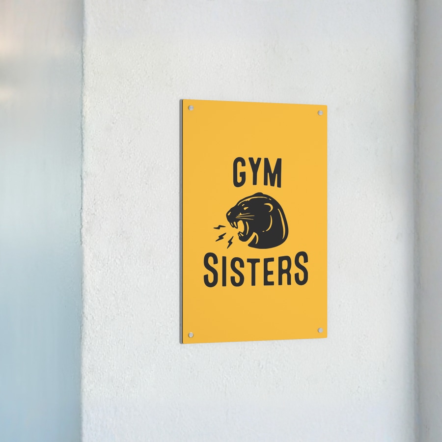 A gym metal sign hanging on a wall.