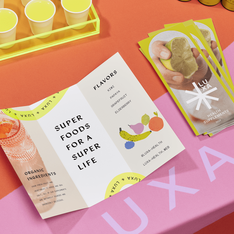 Tri-fold brochures for a health supplements brand, displayed on a colorful table, with samples in the background.