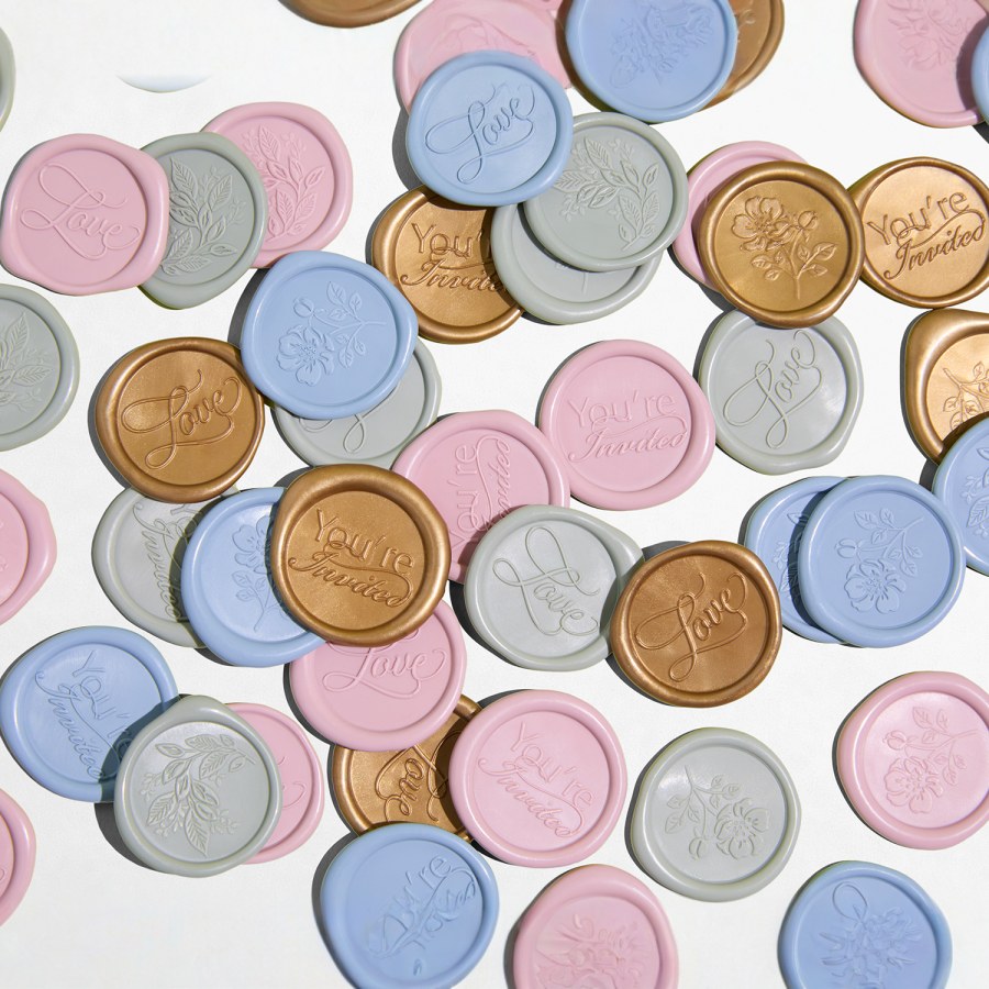 A pile of custom wax seals in a variety of colors and motifs. 