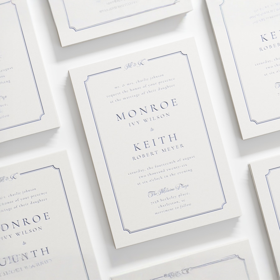 A letterpress wedding invitation featuring a classic font and elegant border. 