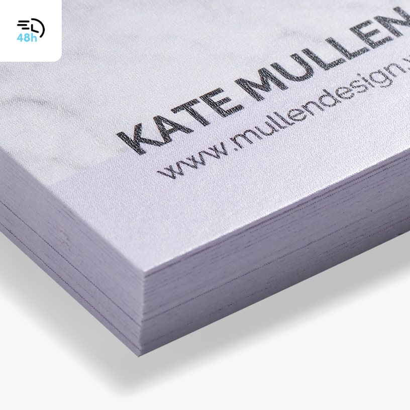 A close-up of a stack of white matte business cards, with a 48-hour delivery icon in the corner.