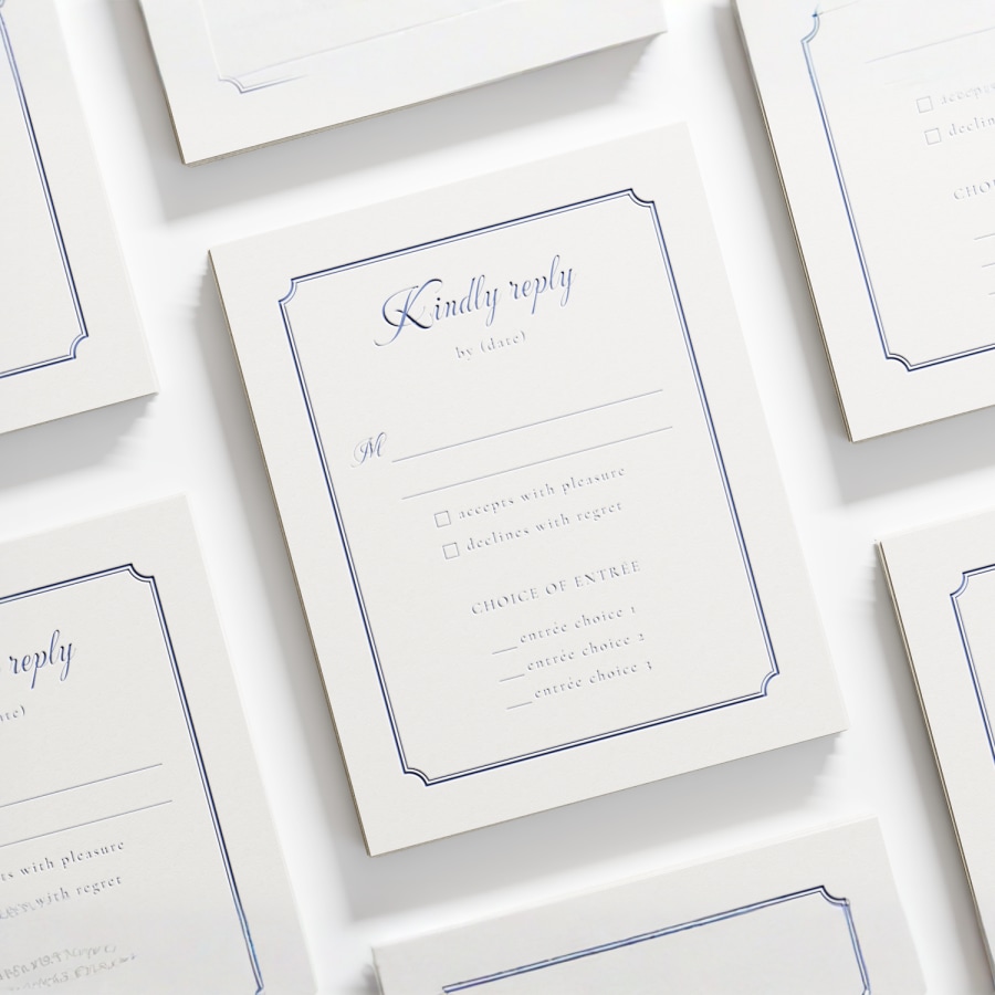 A letterpress RSVP card featuring cursive script. 