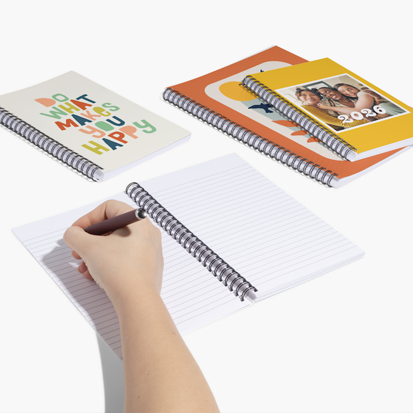 Several custom notebooks featuring photographs and art on the cover.