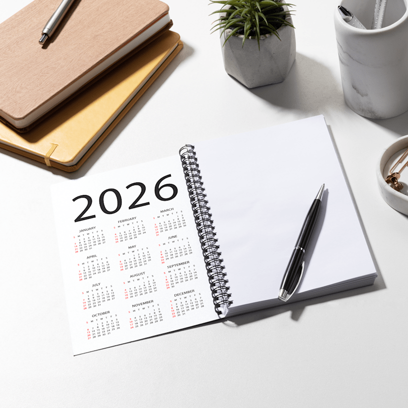 A custom notebook on a desk, featuring a calendar on the inside front cover.