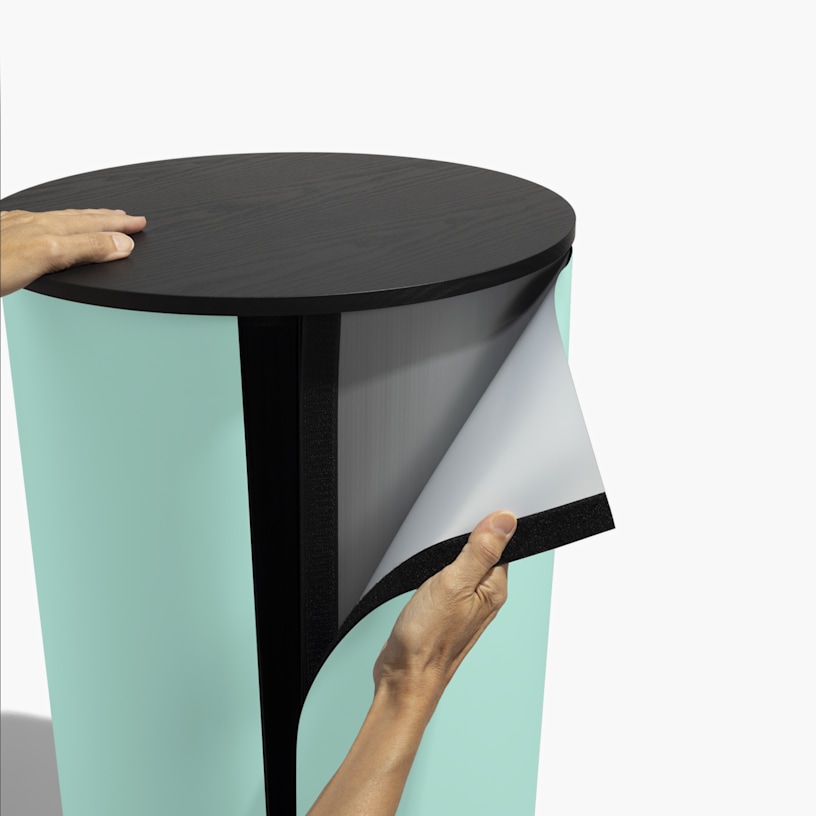 Someone removing the graphic from the round podium counter.