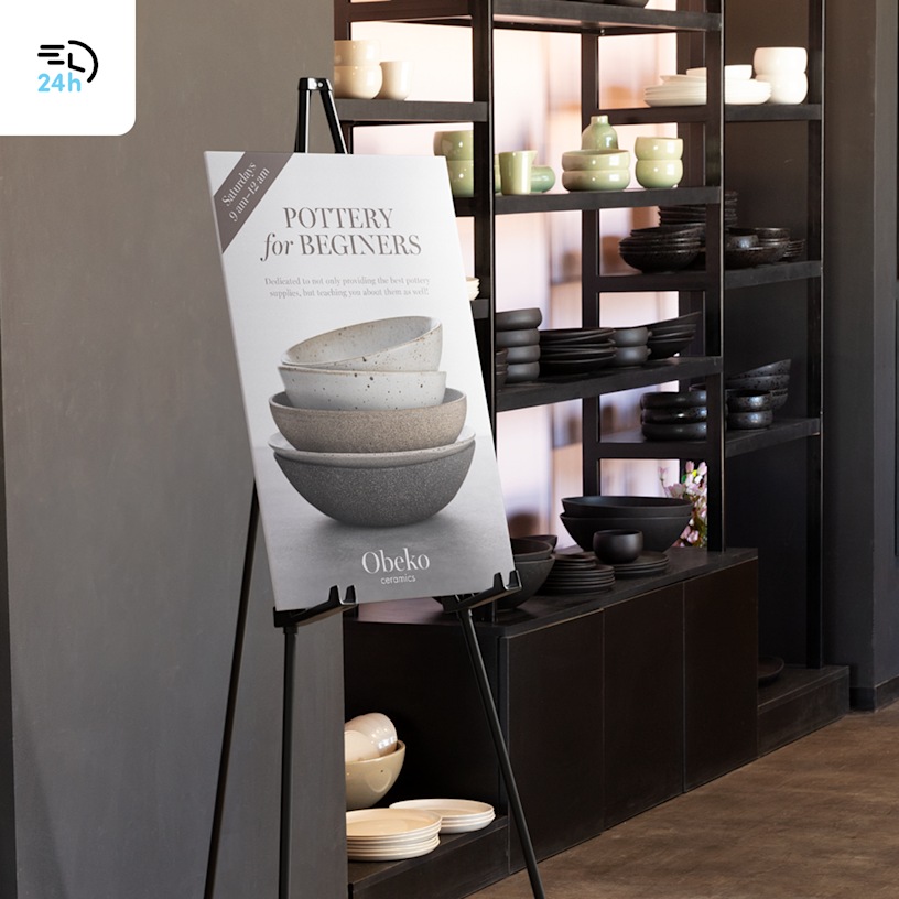  A beginner potter class foam board on an easel standing next to a shelf of pottery, with a 24-hour delivery icon in the corner.