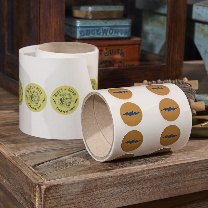 A roll of labels cut to a custom shape of 2 donuts from a cafe.