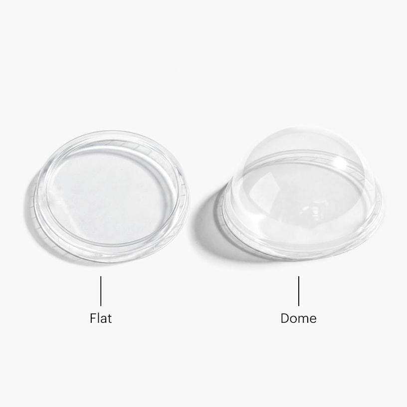 A flat, plastic ice cream cup lid and a domed, plastic ice cream cup lid. 