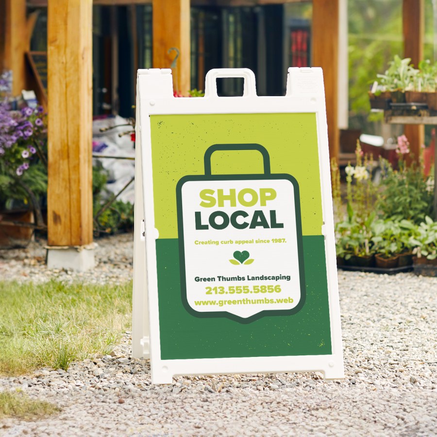  A white Signicade® featuring a landscaping company.