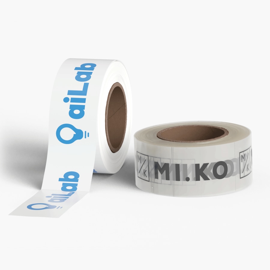 Un rollo de cinta adhesiva de plástico blanca y uno transparente sobre un fondo gris. Ambos con impresión personalizada de diseños de logotipos que se repiten.