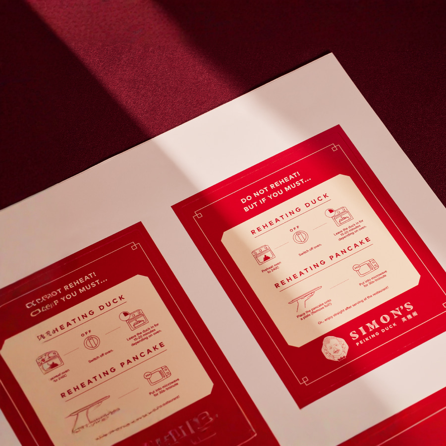 Una hoja de etiquetas de un restaurante de comida asiática, con instrucciones para recalentar su pato y panqueques.