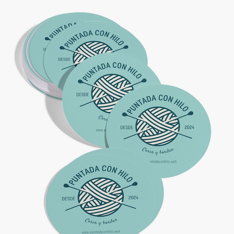 A stack of circle business cards for a knitting and crochet supply store.