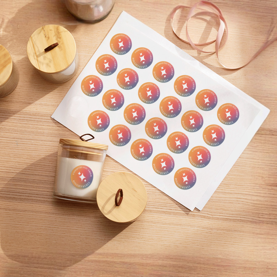 Une feuille d’étiquettes provenant d’une entreprise de bougies, ainsi que plusieurs bougies arborant les mêmes étiquettes.