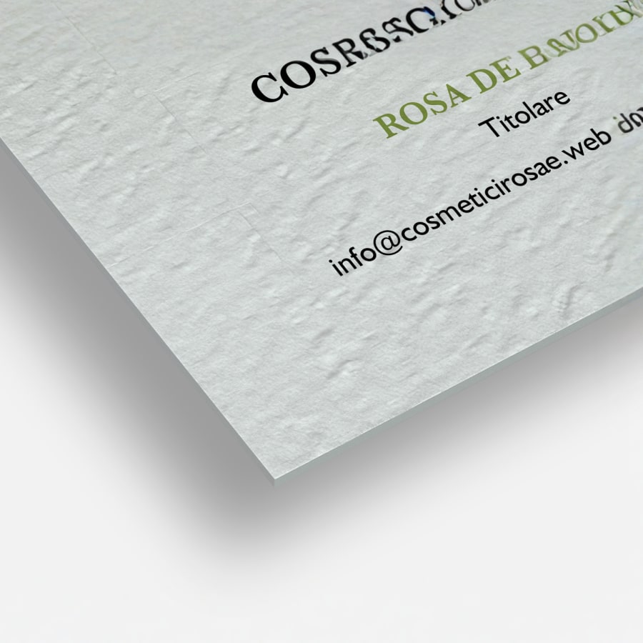 Primo piano su dei biglietti da visita in carta ruvida non patinata che ne mette in evidenza gli angoli squadrati e la particolare trama del materiale che ricorda quella della tela.