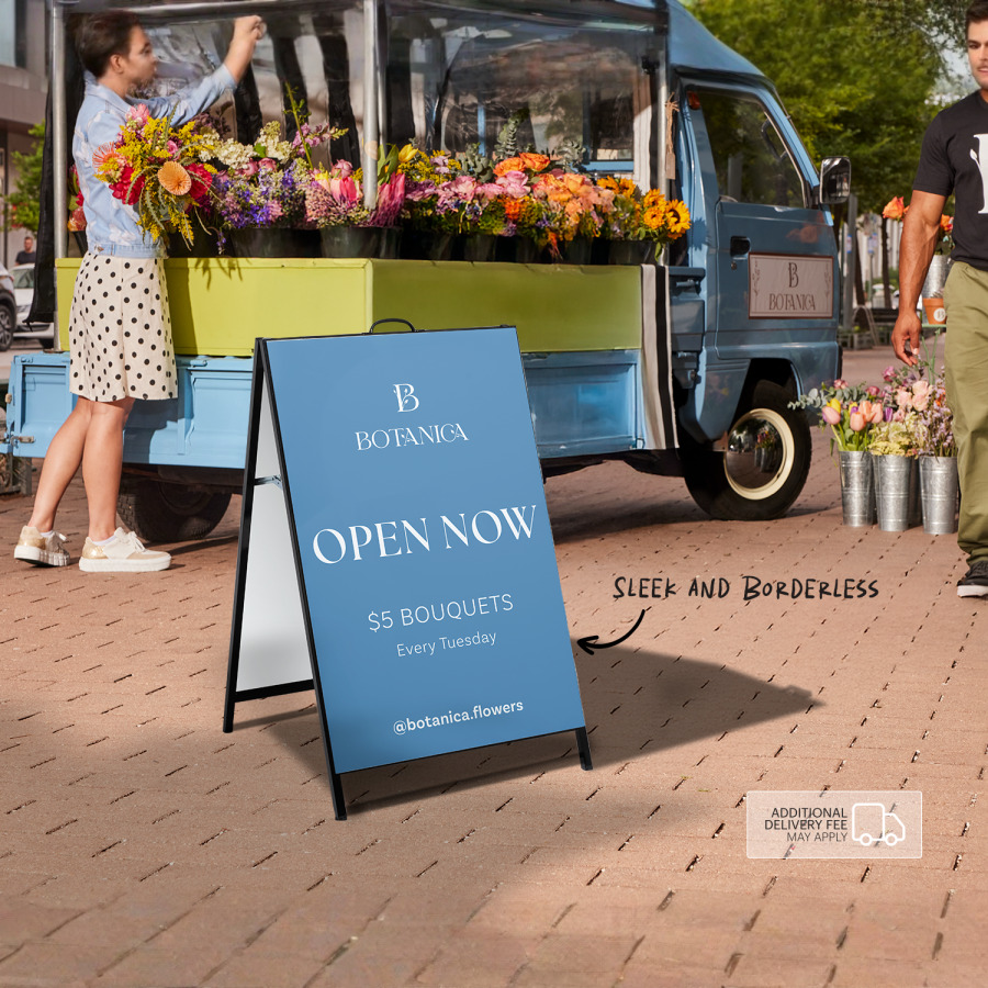 An A-frame promoting a flower shop, displayed outdoors.