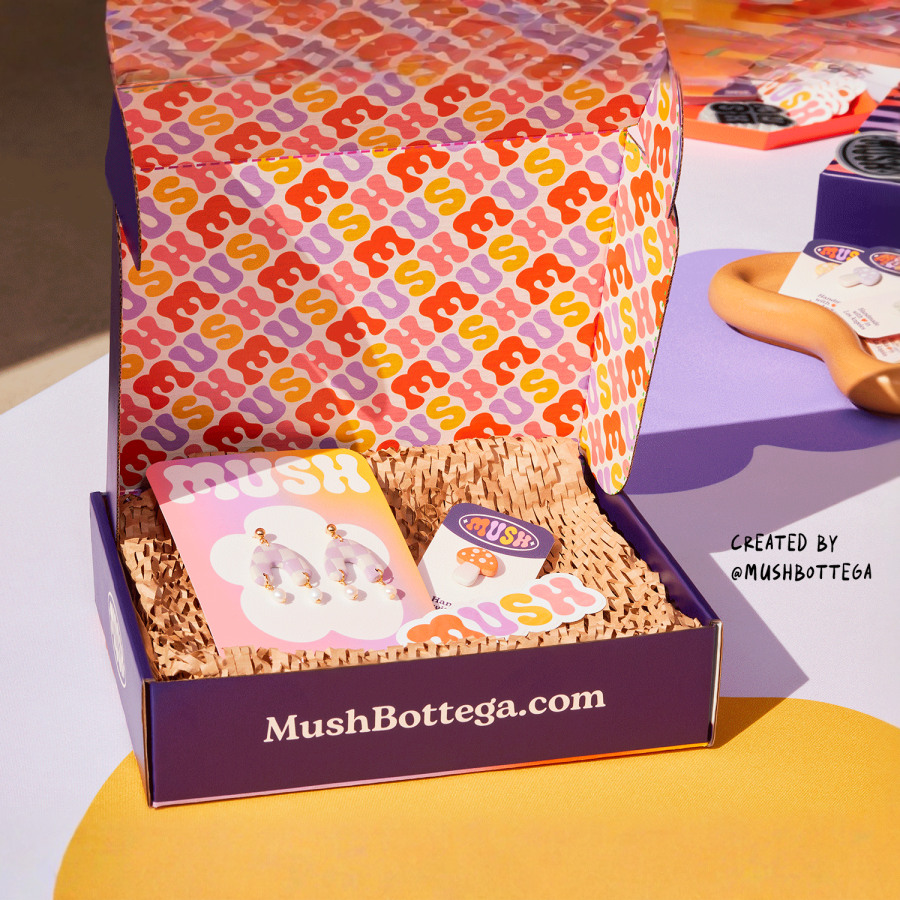 A branded mailing box promoting a jewellery business, with a printed design on the inside.