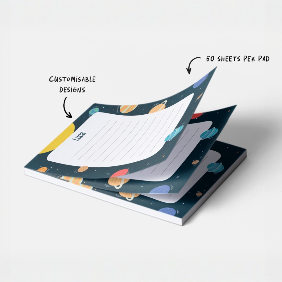 A personalised notepad with a space-themed design.