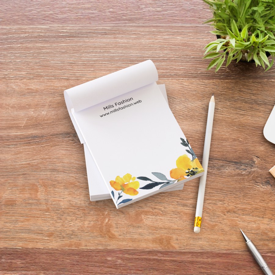 Branded notepads promoting a fashion brand.
