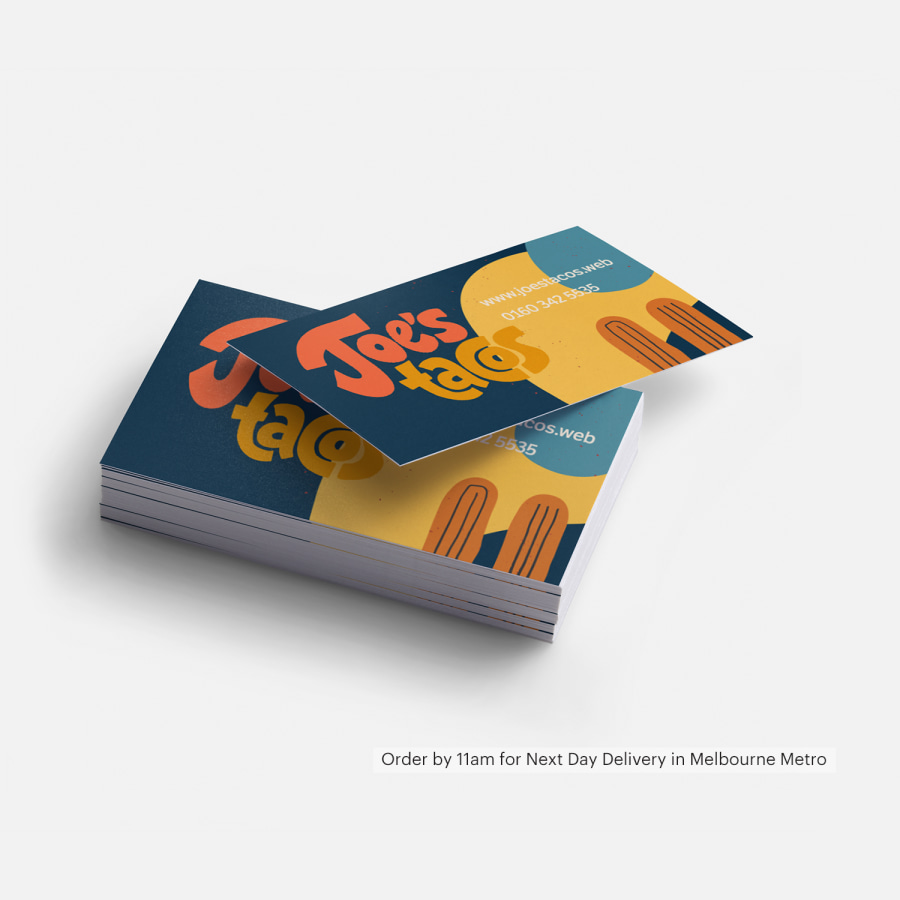 A stack of business cards promoting a taco shop, with a reminder.