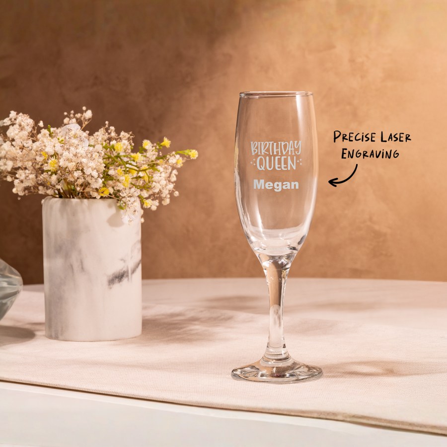 A champagne flute personalised for a birthday celebration, with a text call out that reads; "Precise laser engraving".
