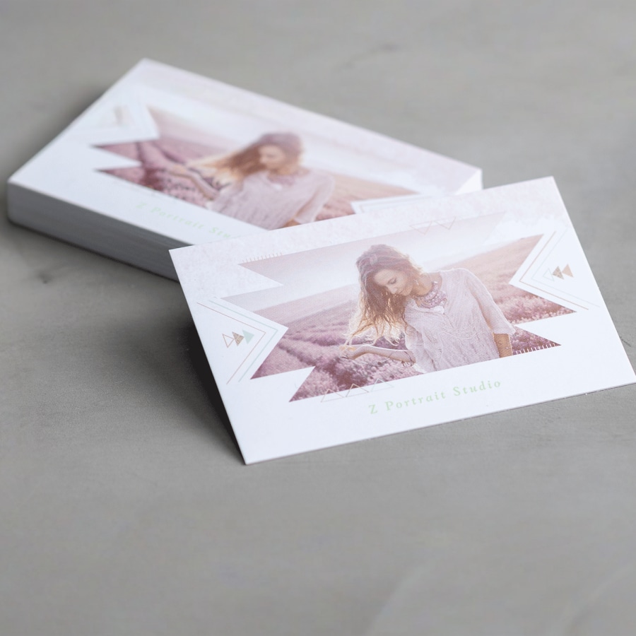 A stack of soft touch business cards featuring a photo studio. 