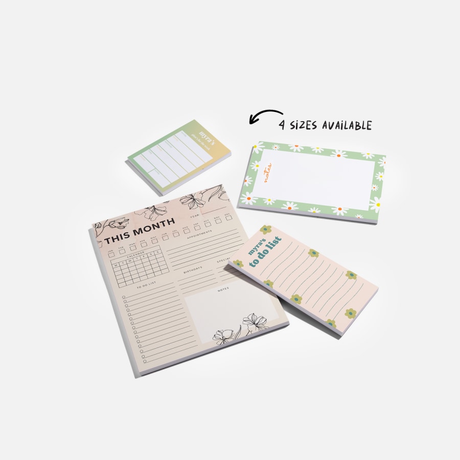 Four different notepad sizes, relative to a ballpoint pen: small, DL, A5 and A4.