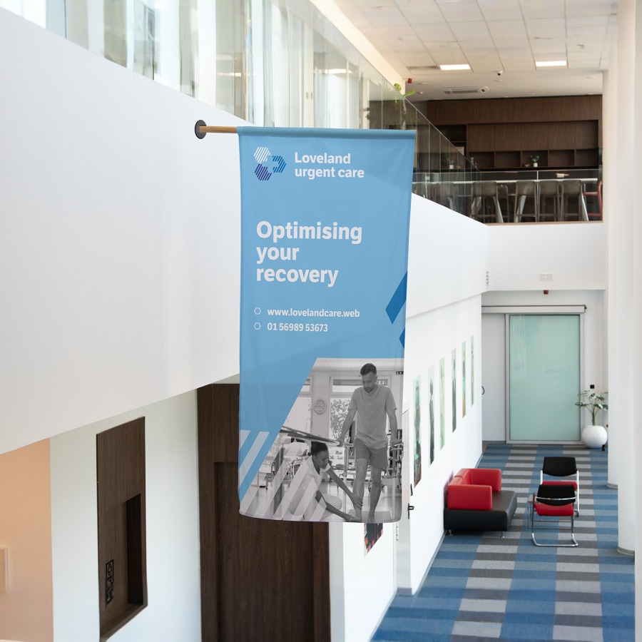 A wall mount flag promoting urgent care services, mounted indoors.