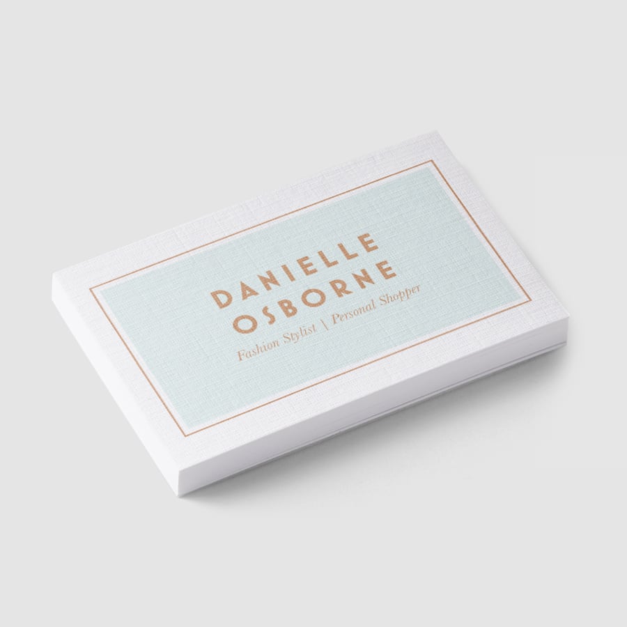 A stack of linen business cards for a manager named Kiki Ramirez.