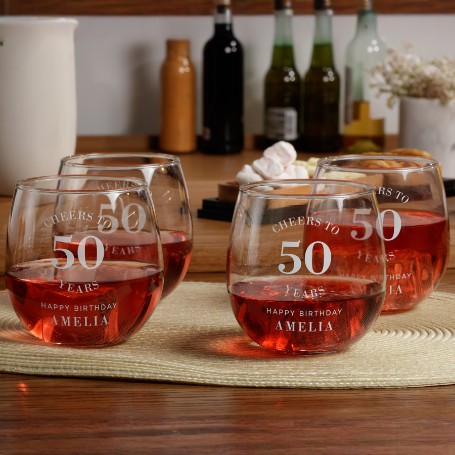 4 stemless wine glasses personalised for a 50th birthday party.