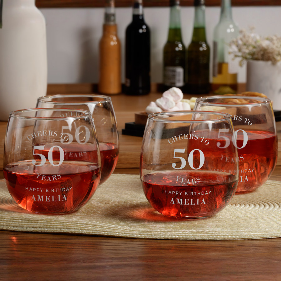 4 stemless wine glasses personalised for a 50th birthday party.