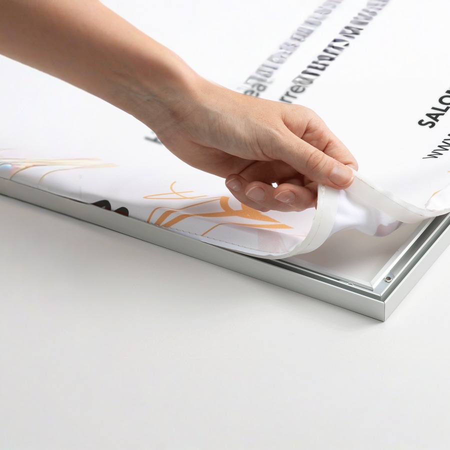 A fabric print being easily removed from its frame, ready to be replaced.