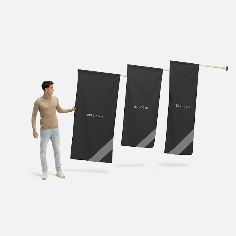 Wall flags in three different sizes, next to a man.