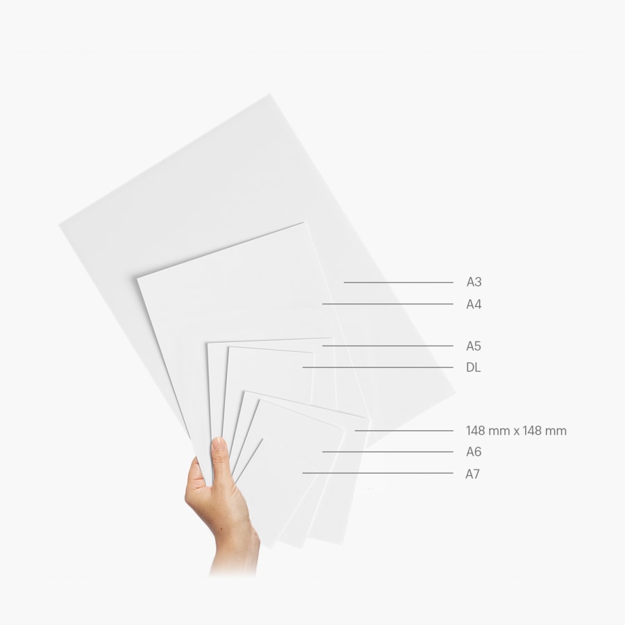 A flyer promoting a specialty cookie store, held in front of a market stall.