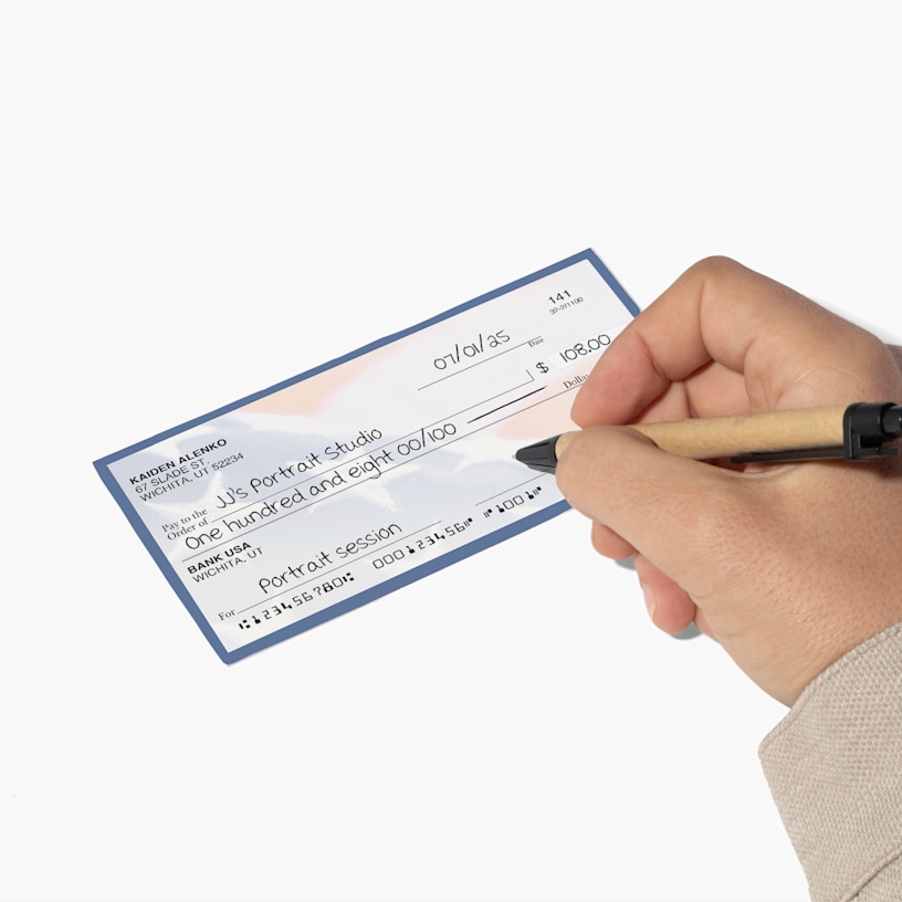 A person filling out a wallet check with their payment info.