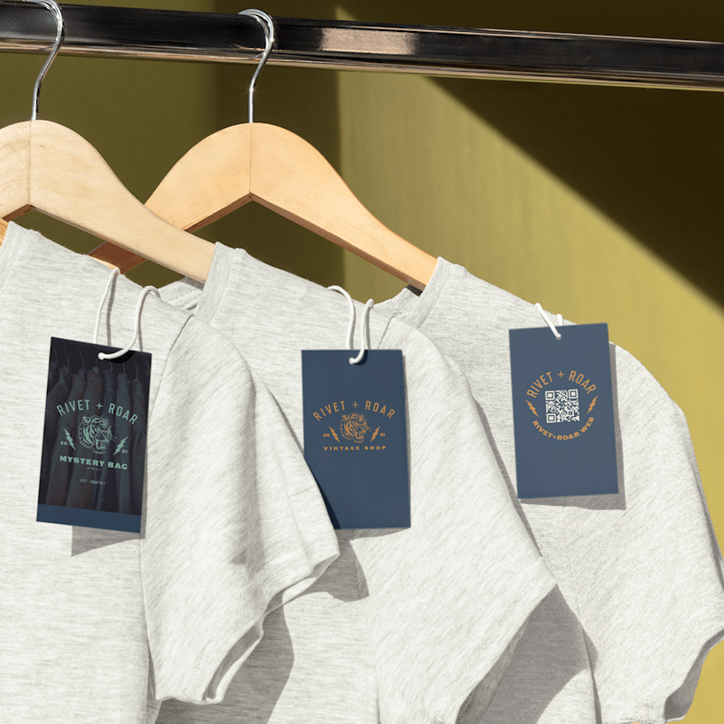 Plastic hang tags on shirts hanging on hangers. 