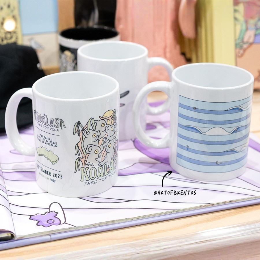 Three white mugs featuring artwork by @artofbrentos