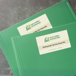 A folder with a business card sticker on the front advertising an accounting business.