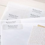 Some letters with return address labels placed in the corners, alongside the sheet the labels had been peeled from.