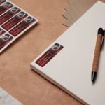 A return address label placed in the top corner of a document, adjacent to a sheet of labels.