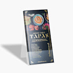 A stack of gold embossed foil rack cards for a restaurant menu, in a plastic holder.