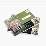 A stack of Every Door Direct Mail (EDDM) postcards, featuring a real estate listing.