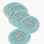 A stack of circle business cards for a knitting and crochet supply store.