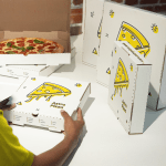 Branded pizza boxes of different sizes.