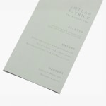 A sage-colored wedding menu customized with various food offerings for a reception. 